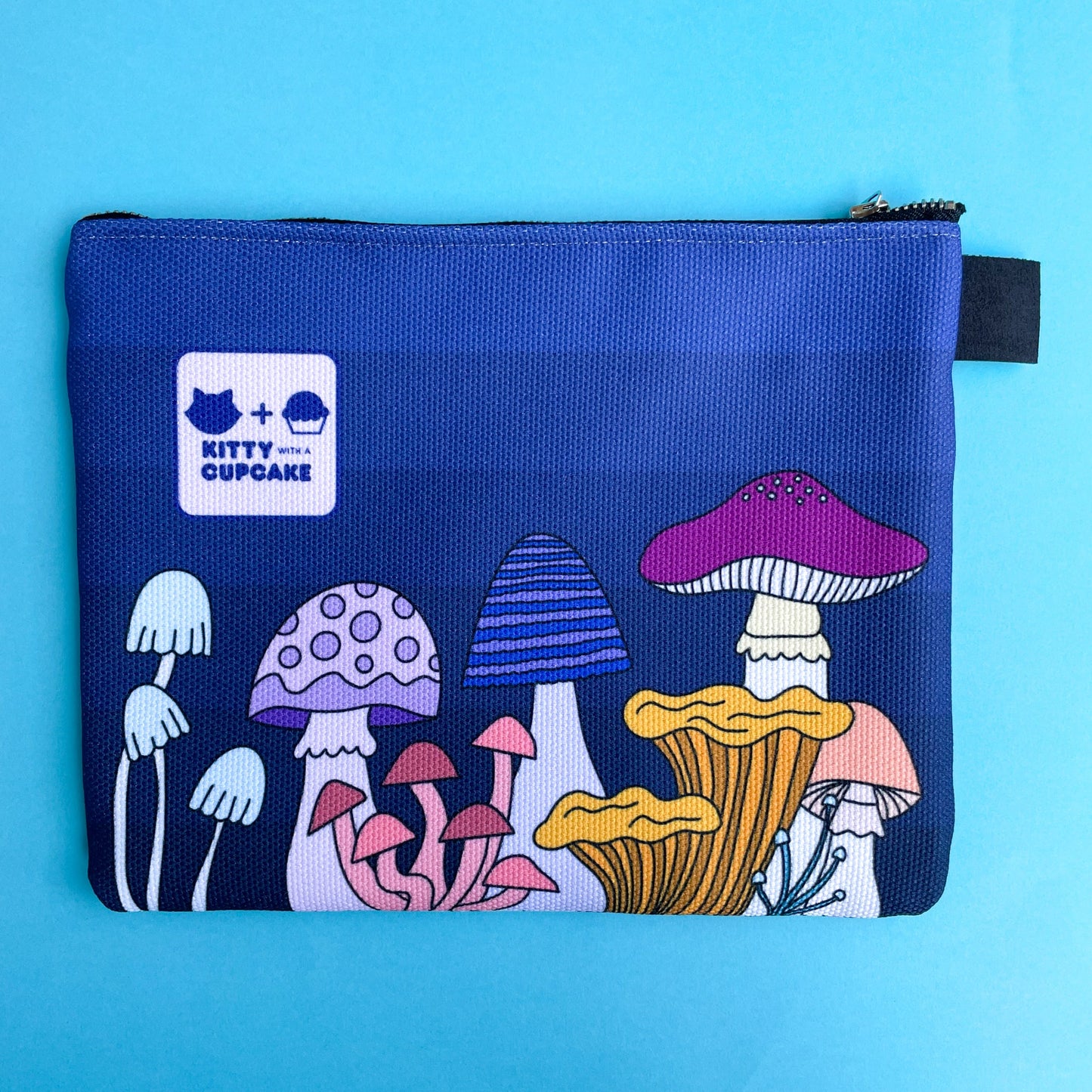 The backside of the bag showing a Kitty With A Cupcake Logo and more different shaped mushrooms including a yellow and pink one.