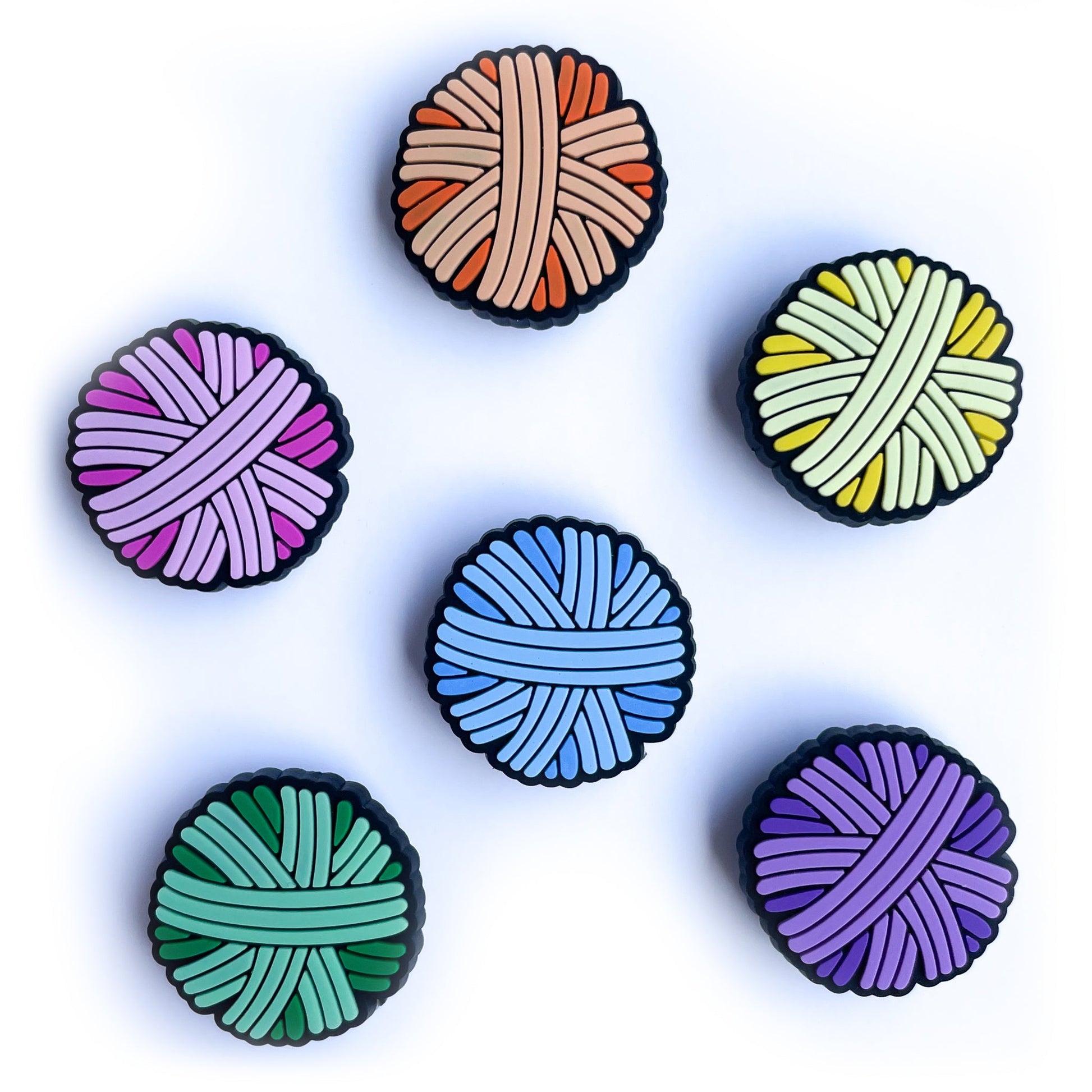 PVC charms shaped like yarn balls in pink, orange, yellow, mint, blue and purple.