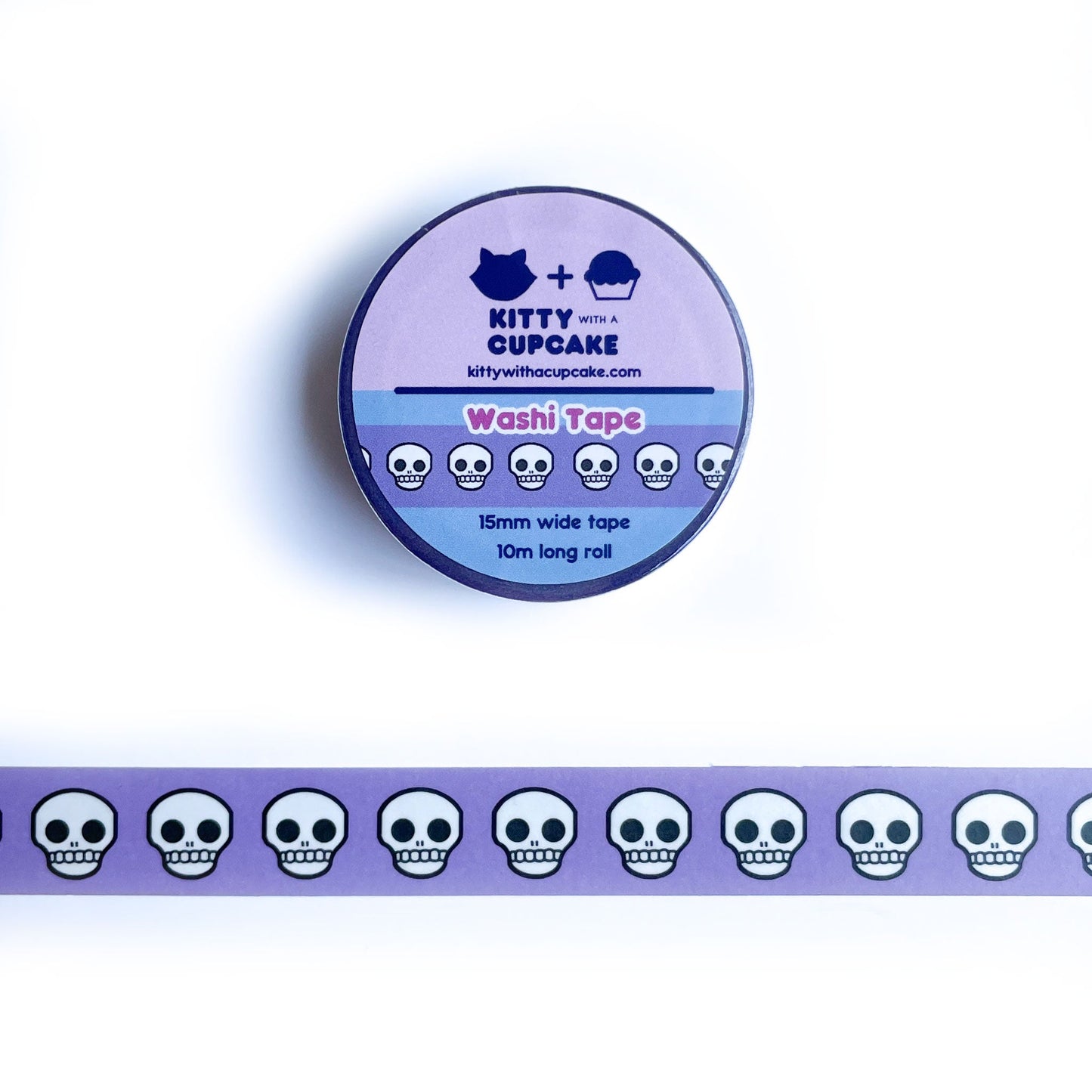 A circular roll of packaged washi tape above a piece of washi tape that has a periwinkle background and grimacing cartoon skulls on it